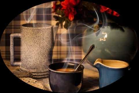 Feel the energy at TimeForTalking, remote Spiritual Mentoring and Life Coaching to improve your life, hot mugs of steaming tea on a desk next to a vase with red flowers